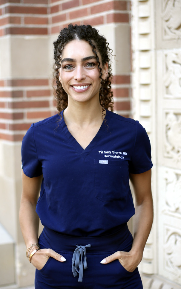Dr. Tiffany Sierro MD board-certified dermatologist performing dermoscopy skin cancer examination same-day biopsy and minimally scarring basal cell carcinoma and squamous cell carcinoma excision at Kare Plastic Surgery Santa Monica Los Angeles